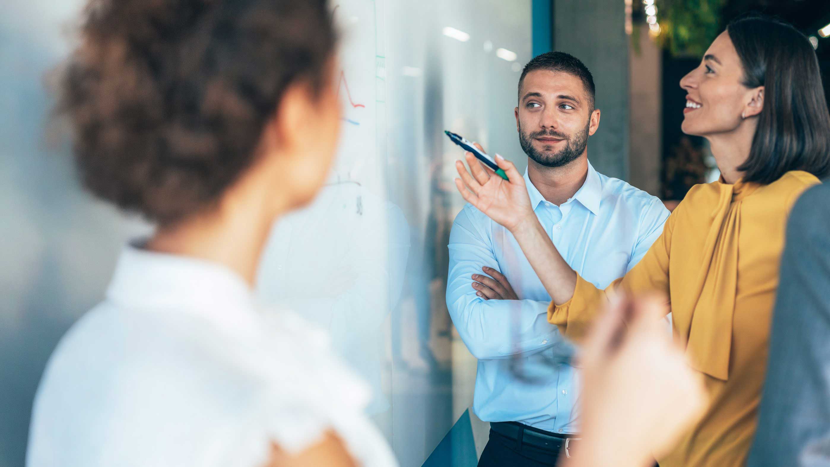 team-in-a-strategy-meeting-with-whiteboard