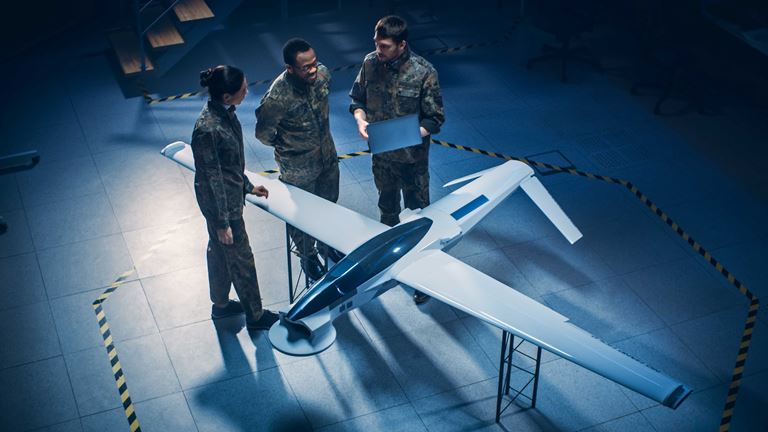 Three people assessing a plane