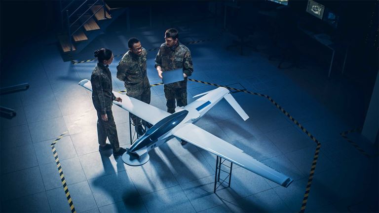 Three people assessing a plane