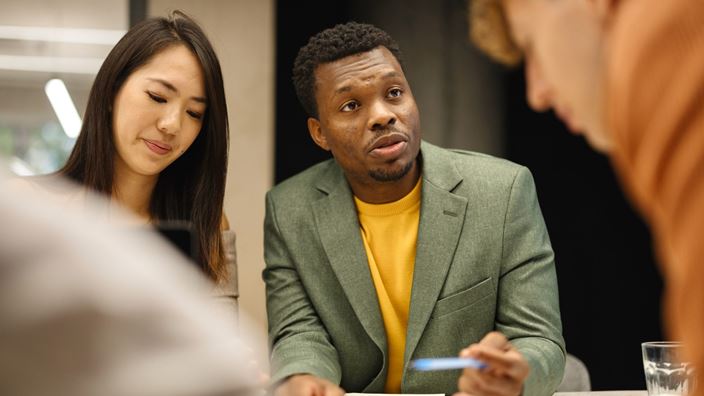three people in a business meeting