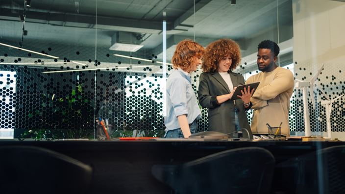 three people with ipad