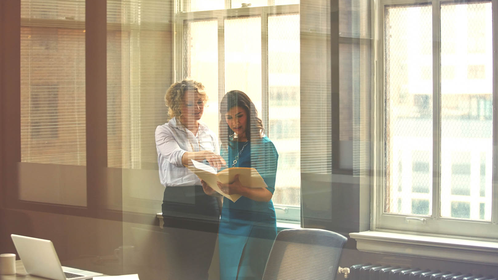 Two business people looking at documents