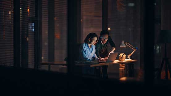 Two colleagues working late in the office
