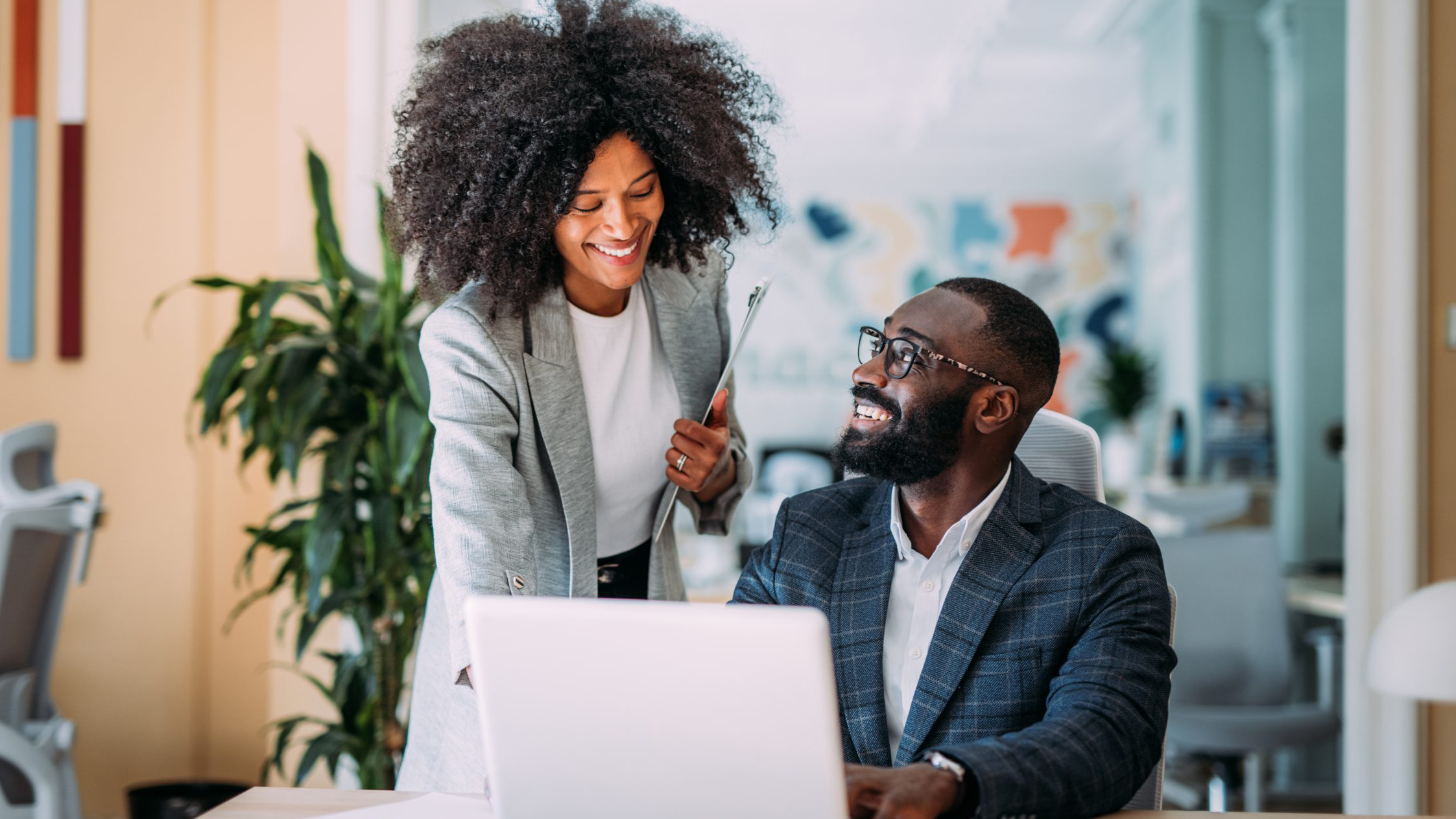 two colleagues working together on a laptop