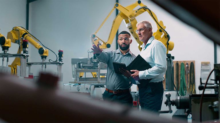 Two engineers assessing the machines