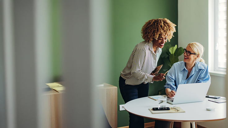 Two ladies looking at laptop