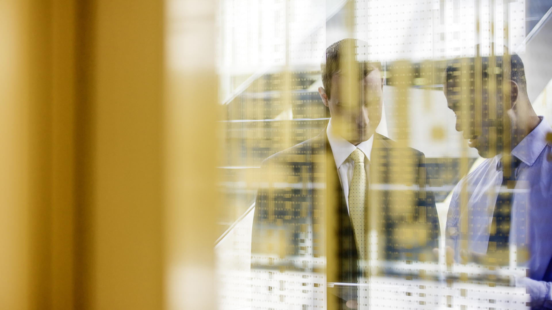 Two managers shot through glass wall