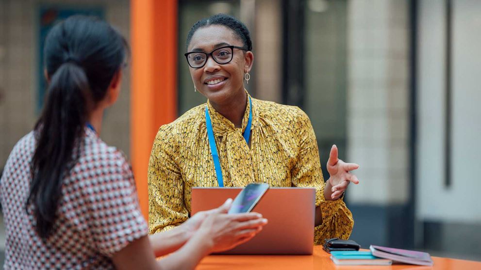 Two teachers in conversation at school