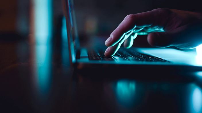 typing-on-laptop-dark-image