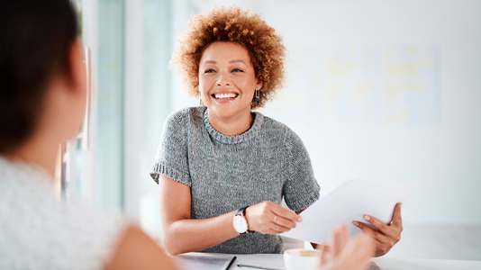woman holding document and smiling