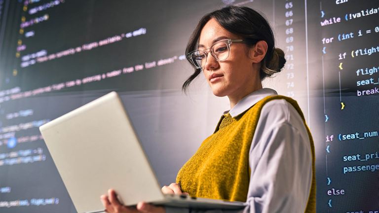 woman holding laptop presenting code