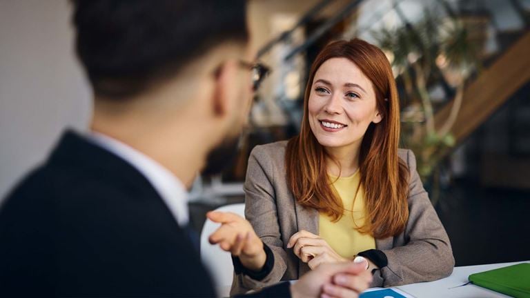 Woman in meeting talking to man