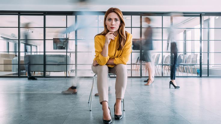 Woman in yellow looking into camera