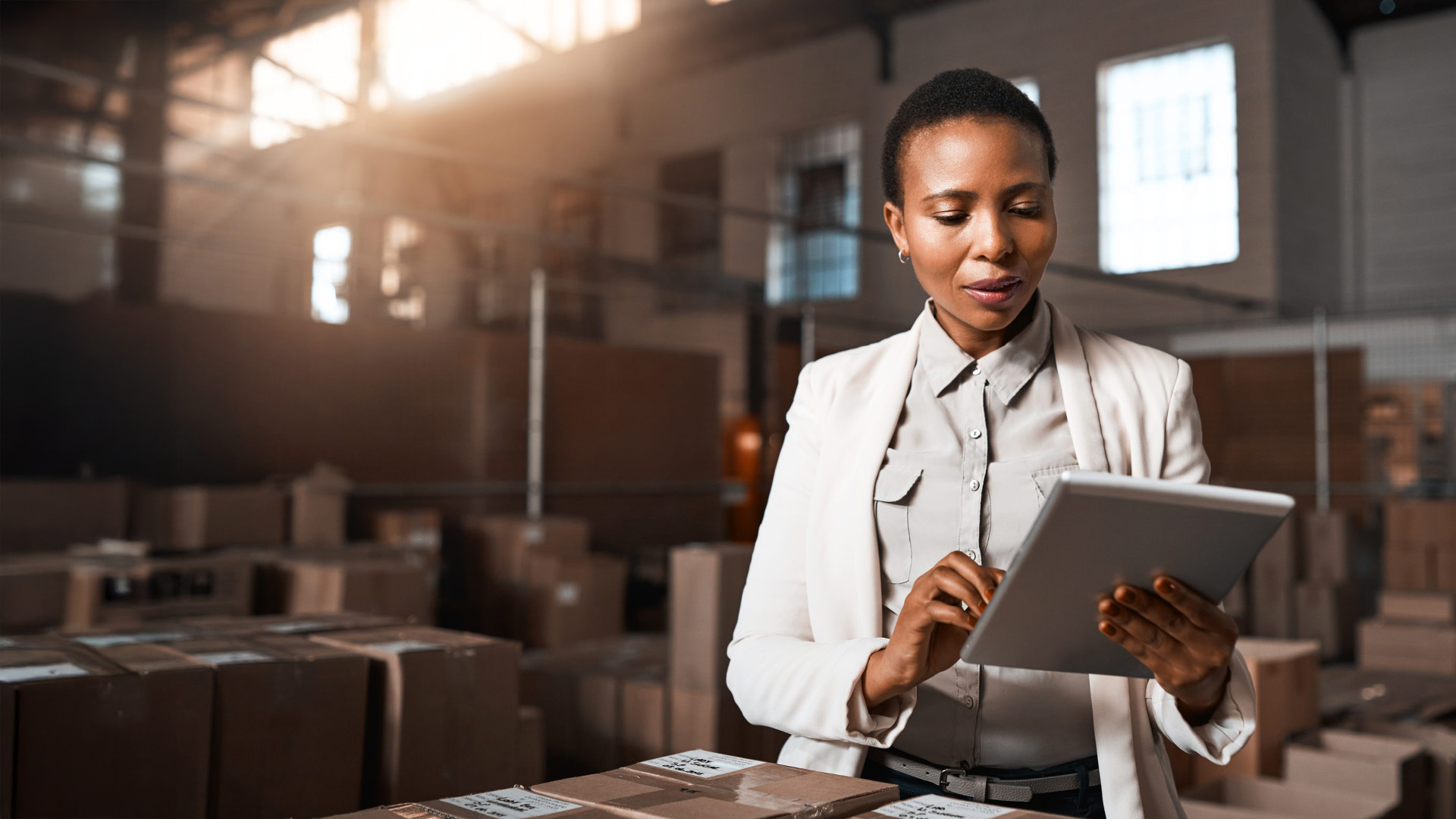 Woman looking at a tablet in warehouse