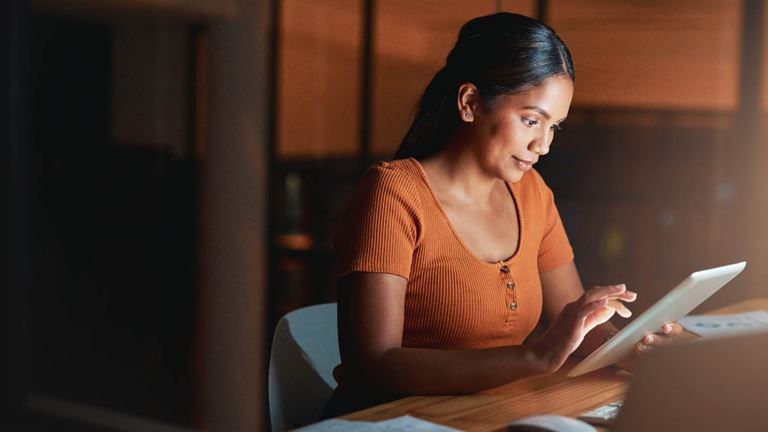 woman on her ipad with laptop