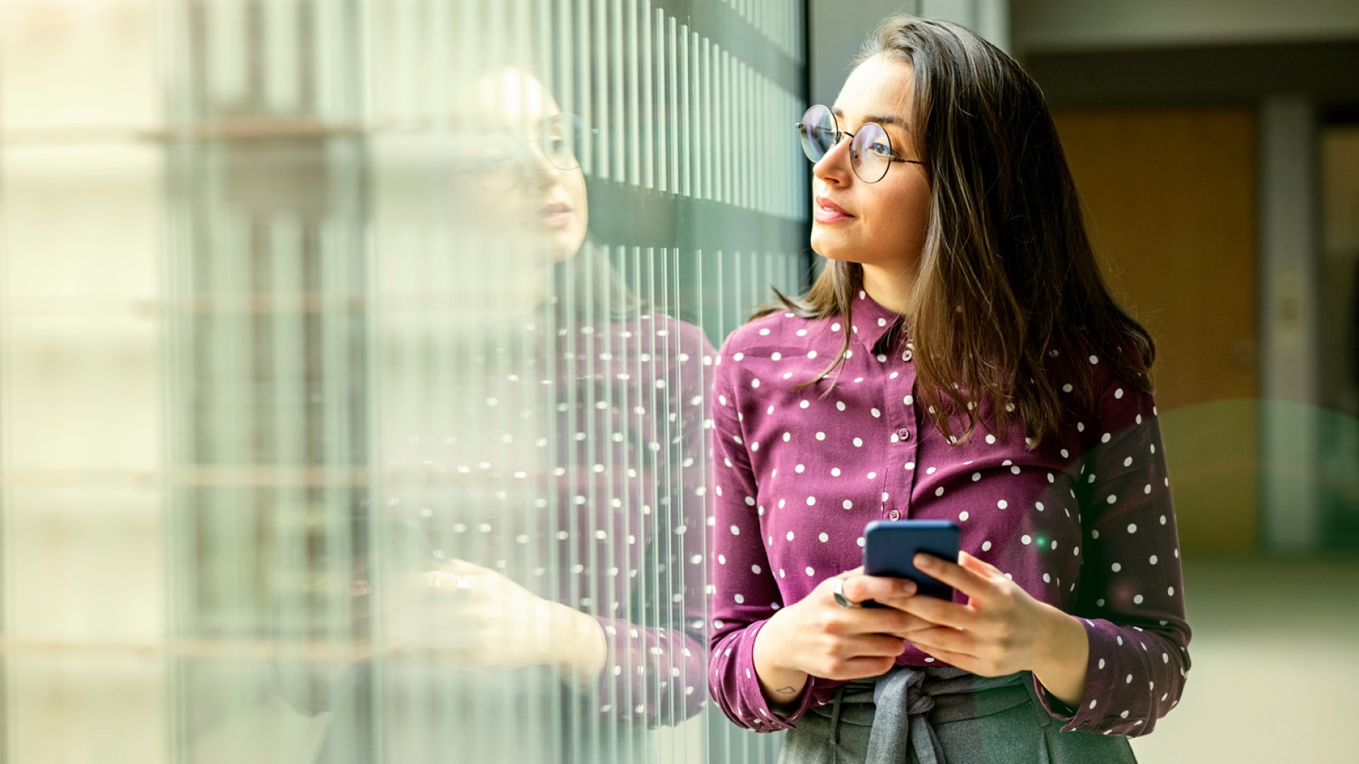 woman on phone looking out of window