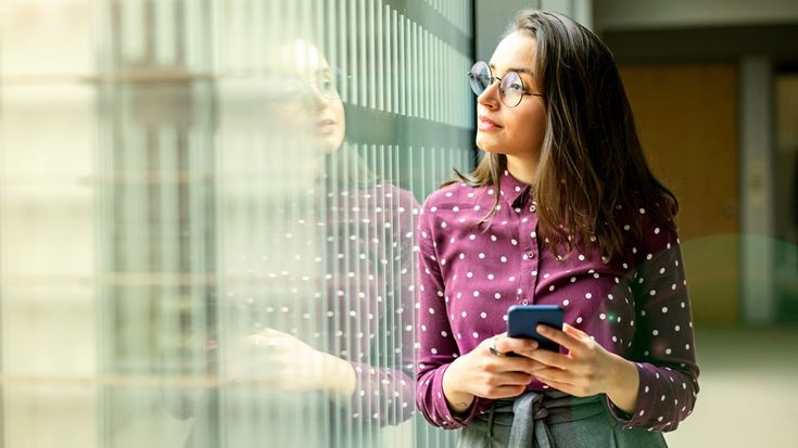 woman on phone looking out of window
