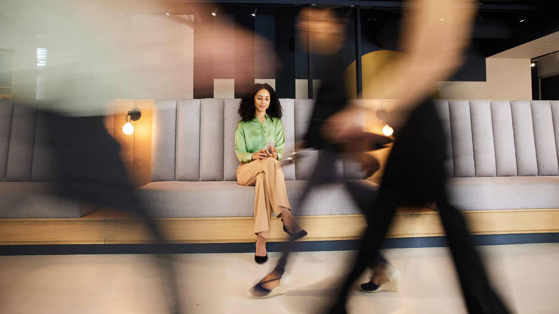 woman on phone with people walking past