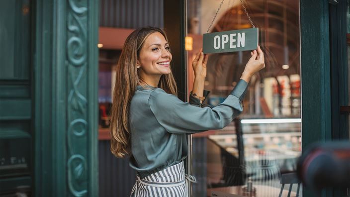 woman opening shop