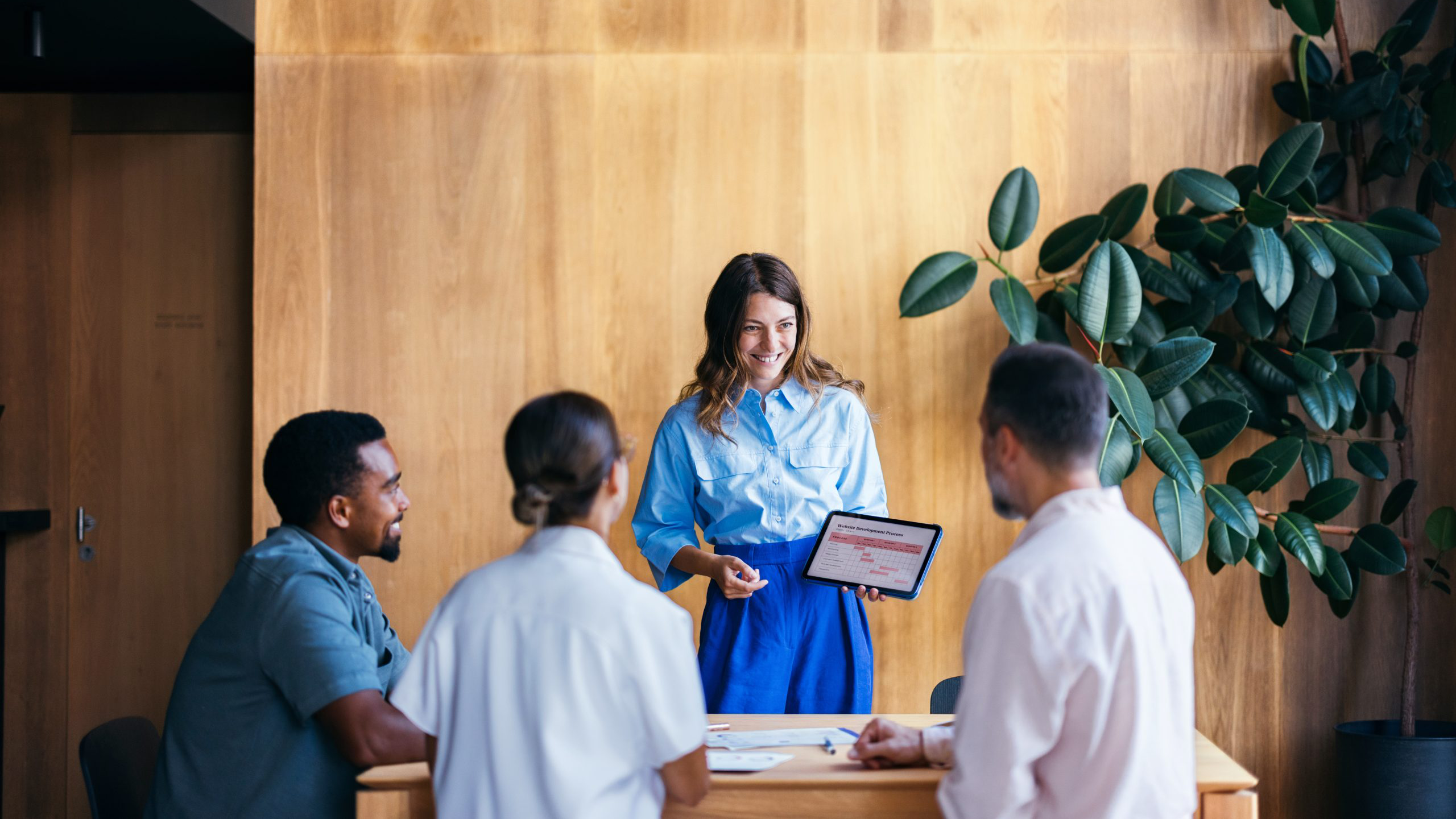 woman presenting strategy to team members in a meeting