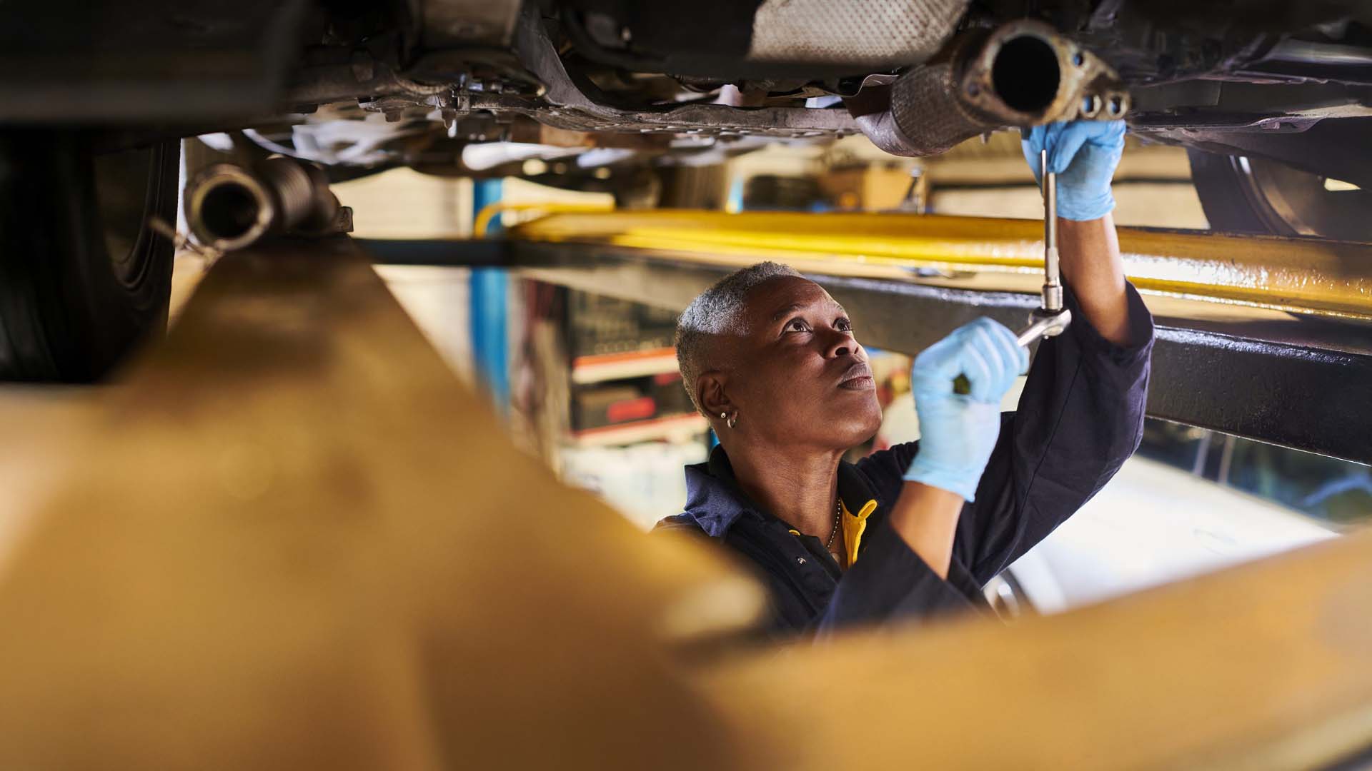 Woman working on car