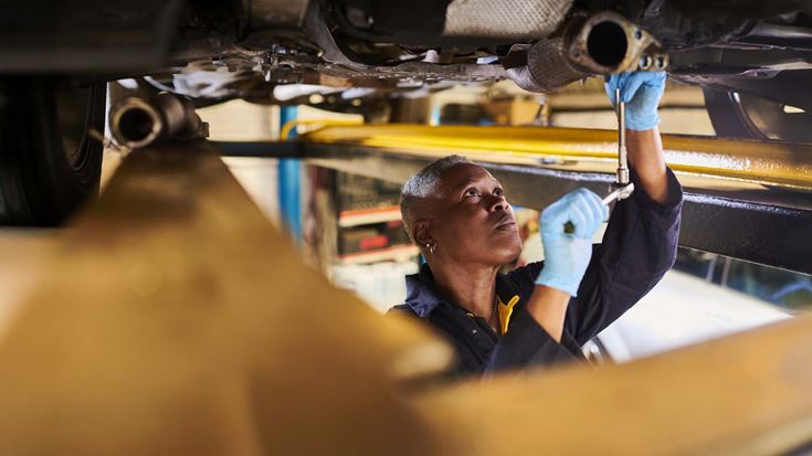 Woman working on car