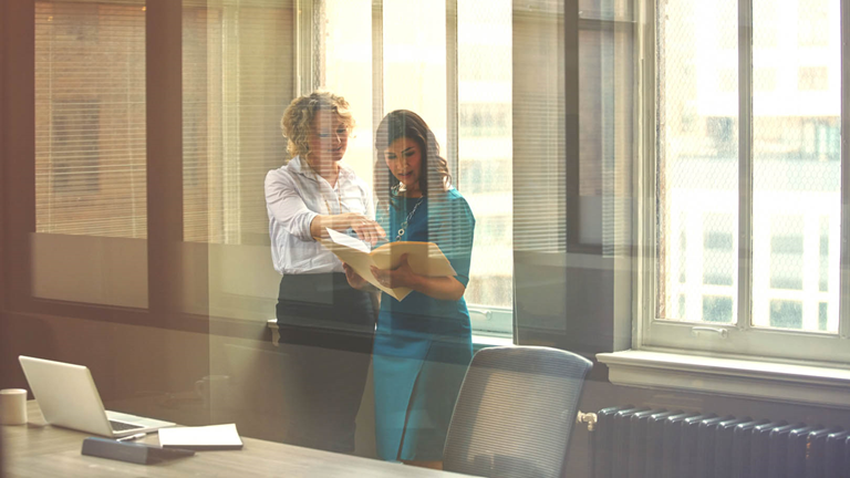 women in office paperwork