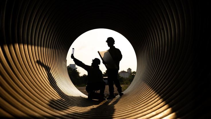 Workers inside pipe