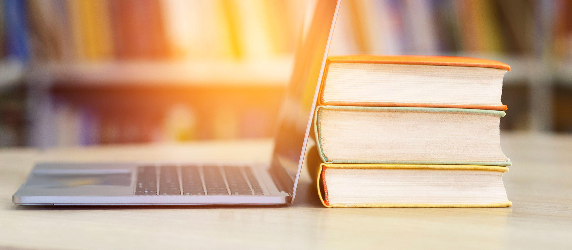 book-and-laptop-in-a-library