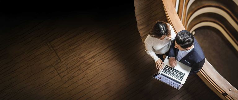 Lady-and-man-looking-at-laptop-from-above.