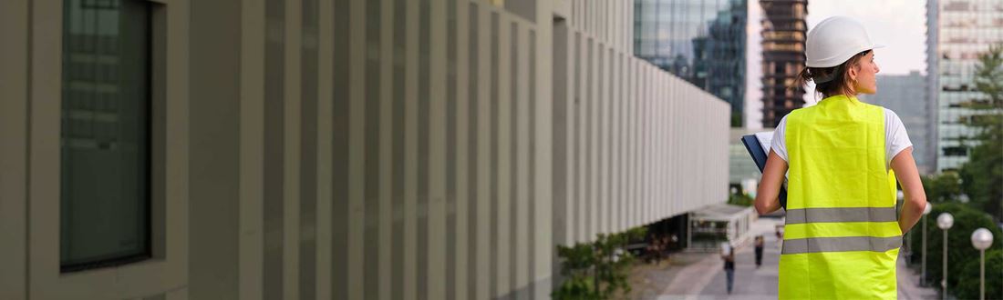 Female engineer inspecting commercial buildings as part of a property assessment