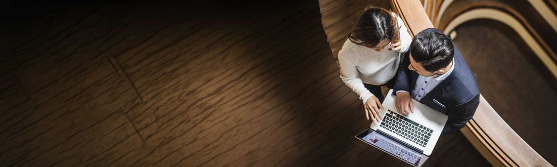Man-and-lady-looking-at-laptop-from-above