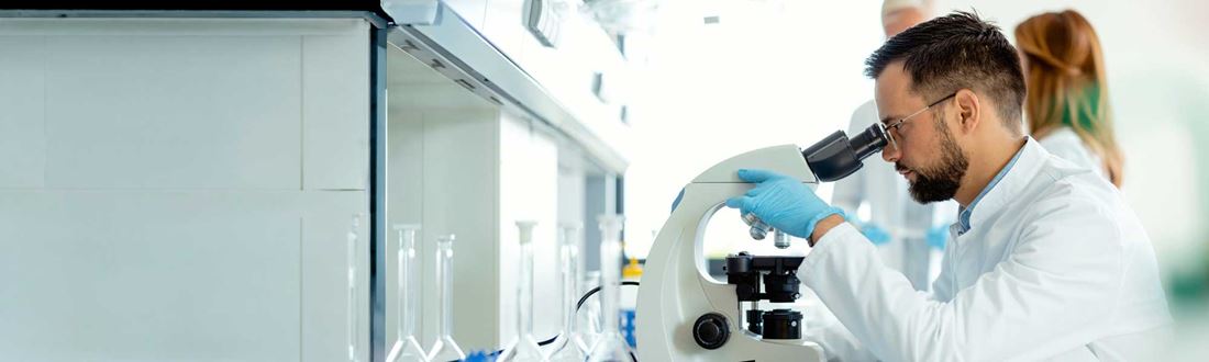 Scientist-looking-through-microscope