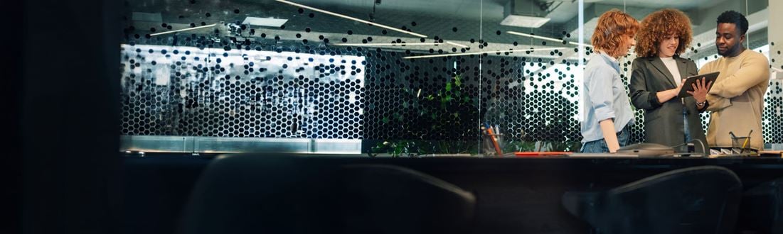 three business people looking at a tablet (1)