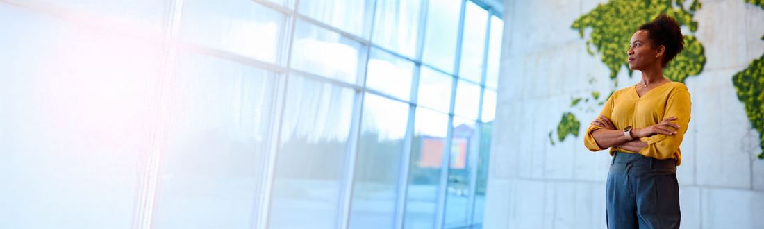 woman looking out of large windows in lobby