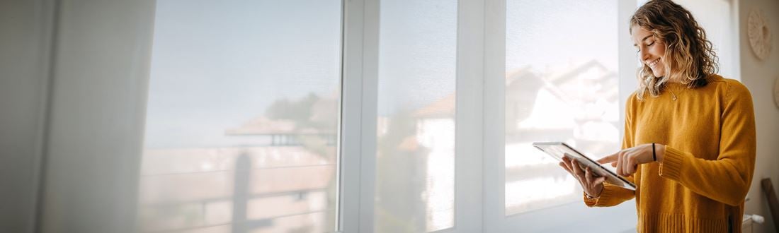 woman smiling looking at a tablet