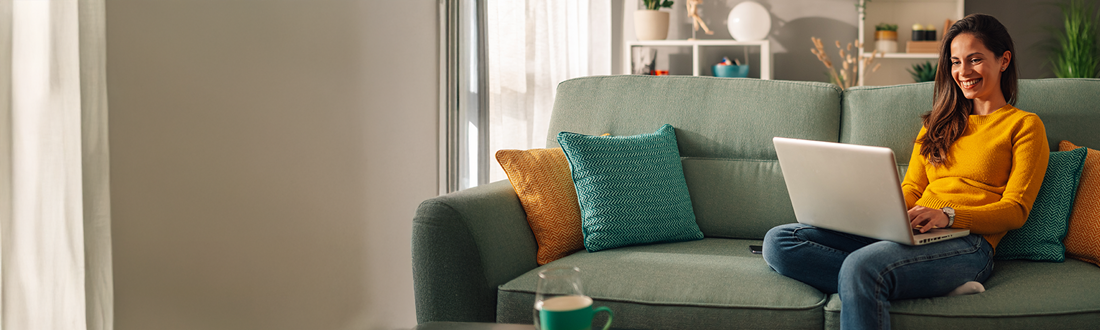 woman working on laptop on sofa