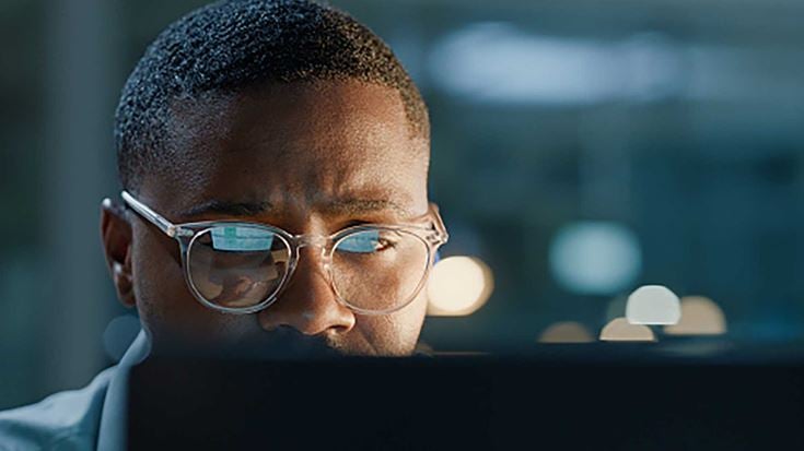 A man working on computer at night