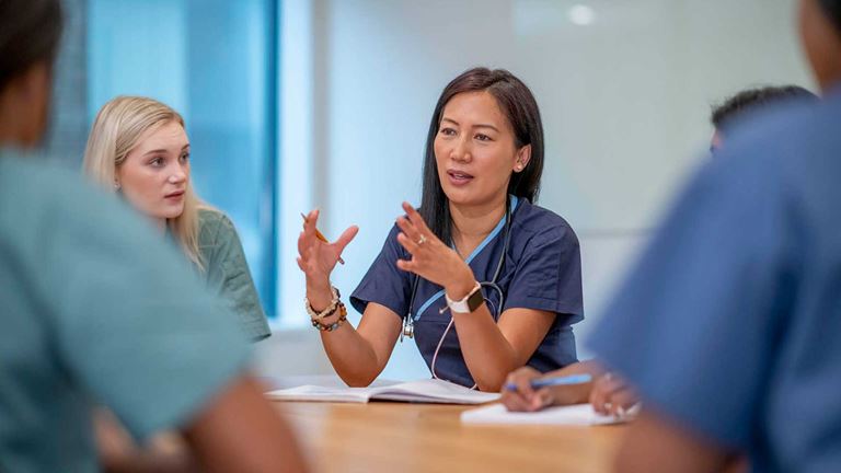 A nurse speaking in a meeting