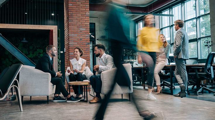 A team meeting in a busy office