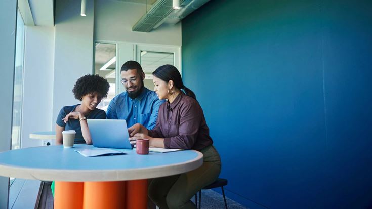 Three colleagues in a collaborative meeting