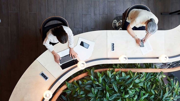 Two professionals working at a desk