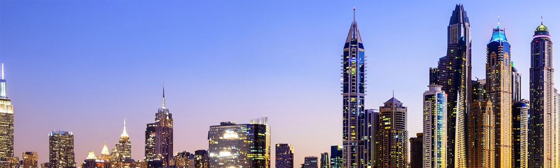 A cityscape on the river at dusk
