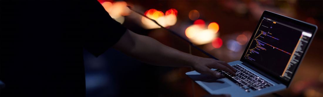 Hands coding on a laptop
