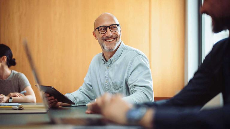 A businessman smiling in a meeting