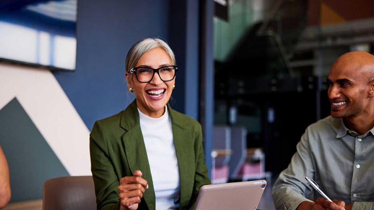 A businesswoman smiling in a financial team meeting