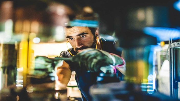 close up of man working on machine