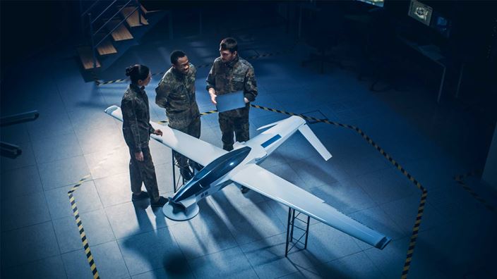 military-people-looking-at-aeroplane-model