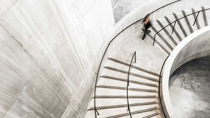 person-walking-down-curved-stairs