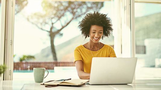 Woman on laptop with folders